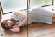 A woman laying on the floor in front of a window.