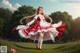 A woman in a red and white dress is dancing in a field.