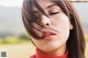 A close up of a woman's face with her eyes closed.